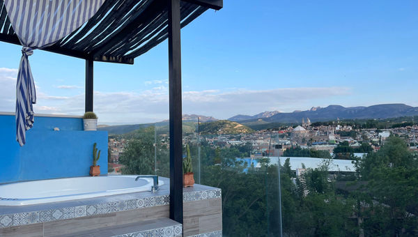 The rooftop spa pool at Casa Bugambilias offers views of the city and the mountains in the distance. The rooftop spa pool at Casa Bugambilias offers views of the city and the mountains in the distance.
