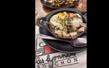 Tripe sausage with poached eggs and potatoes, a traditional Lyonnaise dish served at Bouchon Les Lyonnaise in Lyon, where the Soulful Epicurean Black heritage itinerary docks for two nights while on the Rhone River in France.