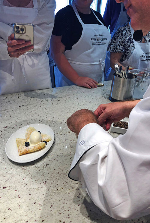 Stephano adds blueberries as a final touch to crepes dusted with powdered sugar and topped with allspice ice cream. Stephano adds blueberries as a final touch to crepes dusted with powdered sugar and topped with allspice ice cream.