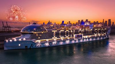 The Icon of the Seas lit up at night in Miami.