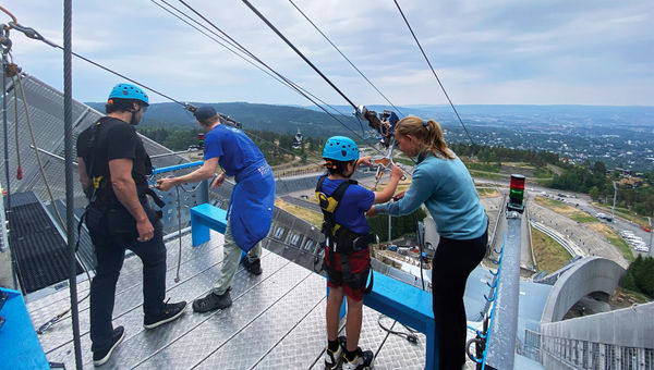 Suiting up for the only-in-Oslo experience of ziplining down a ski jump, a 1,184-feet course with a drop of more than 350 feet.