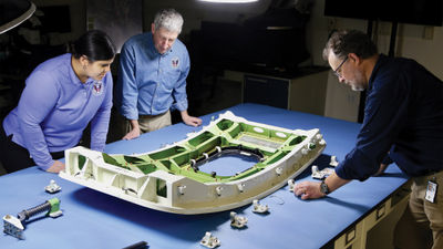​Investigators from the NTSB examine the door plug that blew out on a Boeing 737 9 Max flown by Alaska Airlines.