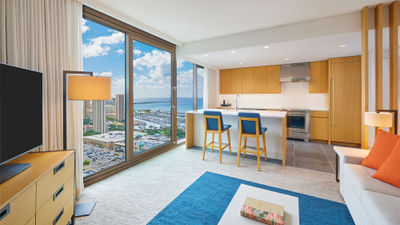 One of Renaissance Honolulu Hotel & Spa’s residences with a living room, kitchen and ocean view.