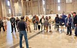 Guests from a Napa Valley Wine Train tour listen to one of the managers at Charles Krug winery in St. Helena talk about the winery's history, the kinds of wines it produces and their winemaking process from start to finish.