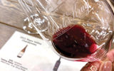 Close examination of a red wine produced at the Charles Krug Winery, one of three visited on the six-hour Legacy Experience.