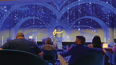The Carnival Jublilee's cruise director, Kyndall Magyar, on stage.