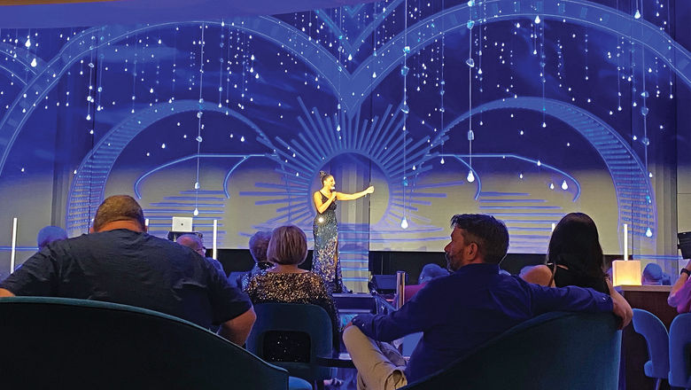The Carnival Jublilee's cruise director, Kyndall Magyar, on stage.