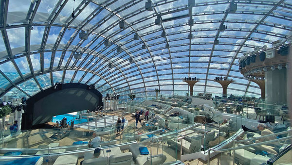 Light shines through the Dome on the Sun Princess as guests swim in the indoor/outdoor pool.
