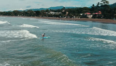 A Surf Synergy guest surfing in Jaco, Costa Rica.