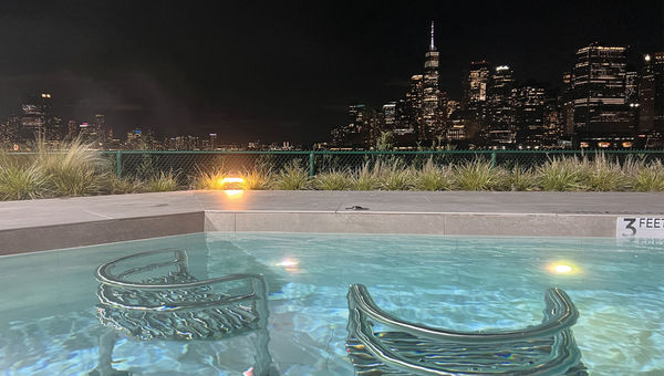 Chairs submerged under a pool heated to 90 degrees Farenheit face an unparalleled view of lower Manhattan. Chairs submerged under a pool heated to 90 degrees Farenheit face an unparalleled view of lower Manhattan.