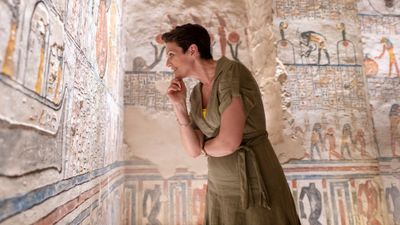 A traveler examines the tomb of King Ramesses VI in Luxor, Egypt.