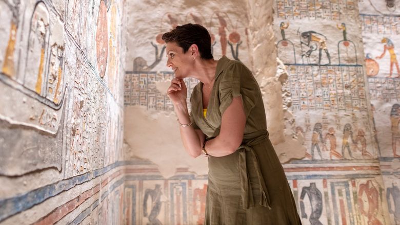 A traveler examines the tomb of King Ramesses VI in Luxor, Egypt.