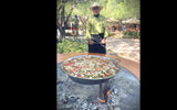 Felipe Geraldo, the chef at El Minereo de Triunfo, prepares a paella over an open fire.