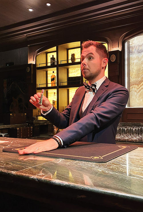 Magician Mark Gibson, who began practicing at the Magic Castle as a child, entertains guests at the bar. Magician Mark Gibson, who began practicing at the Magic Castle as a child, entertains guests at the bar.