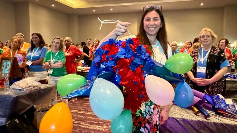 Lindley Diecks, an advisor with Greater Pittsburgh Travel, holds up a piñata that her advisor team crafted during the ALGV Pros on the Go give-back activity.