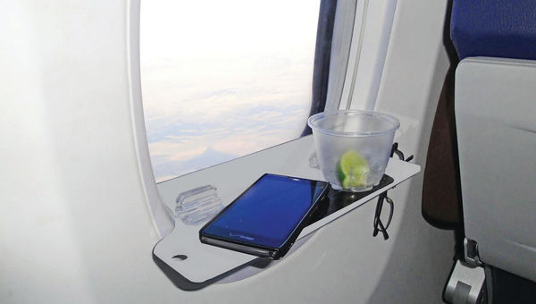 The spAIRtray fits into the window slats on most commercial aircraft.
