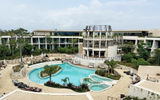An overview of the main pool area and property complex at Secrets Tulum Resort & Beach Club, a Hyatt all-inclusive resort.