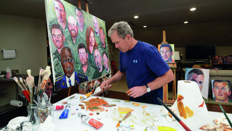 Former President George W. Bush working on one of his portraits of service members.