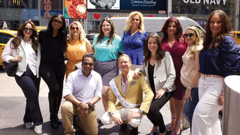 Carson Kressley poses with travel advisors in New York's Times Square on Global Travel Advisor Day.