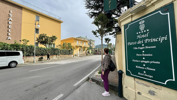 Irene Capano, a Perillo tour guide, stands in front of the high-end Hotel Parco dei Principi in Sorrento, across the street from Hotel Isabella.