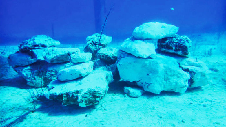 Limestone rocks placed under the trestle pier for Lookout Cay at Lighthouse Point create a new fish habitat.