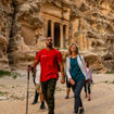 An Intrepid guide leads a group through the ancient city of Petra.