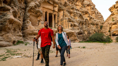 An Intrepid guide leads a group through the ancient city of Petra.