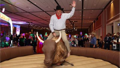 ASTA president and CEO Zane Kerby rode a mechanical bull during the Jubilee welcoming event at the Travel Advisor Conference in Dallas.