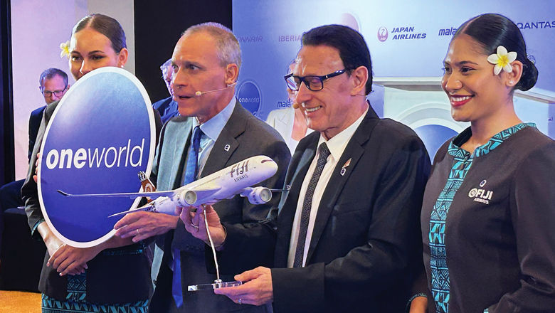 Fiji Airways CEO Andre Viljoen, second from left, marks the carrier's acceptance as full Oneworld member with the alliance's CEO Nathaniel Pieper, third from left, in Dubai on Monday.