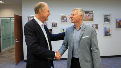 Southwest CEO Bob Jordan (right) shakes hands with former CEO and current chairman Gary Kelly in February 2022. An activist investment firm is calling for both to be removed.