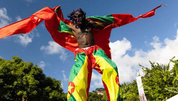 A stilt walker takes part in Grenada’s 2022 Spicemas festival.