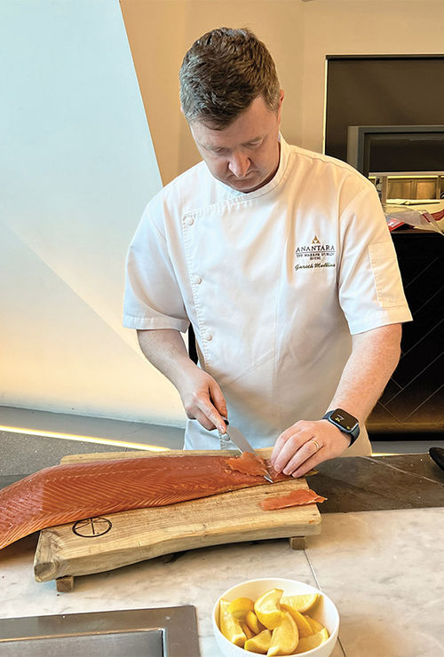 Anantara The Marker Dublin Hotel executive chef Gareth Mullins demonstrates the proper way to slice smoked salmon.