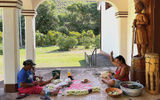 Two women outside a church on Ua Huka string leis.