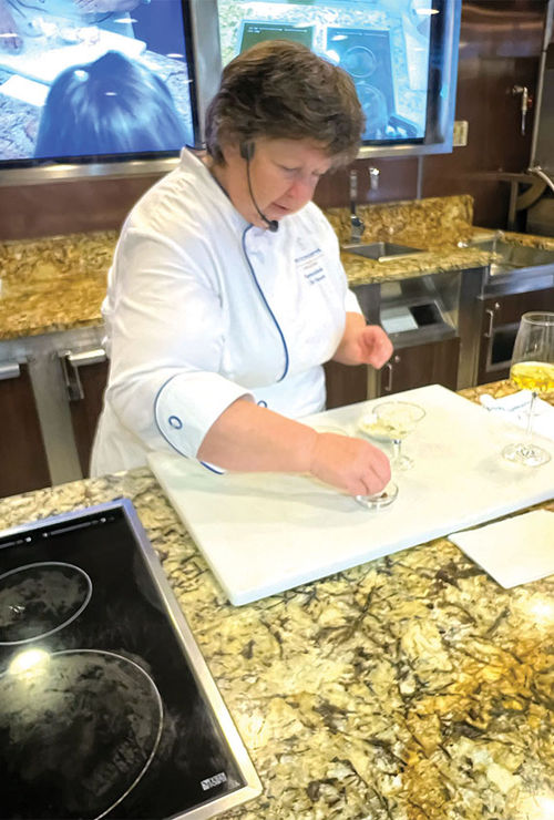 Master chef Stephanie Hersh, a former executive assistant to Julia Child, leading a class in the ship's cooking school.
