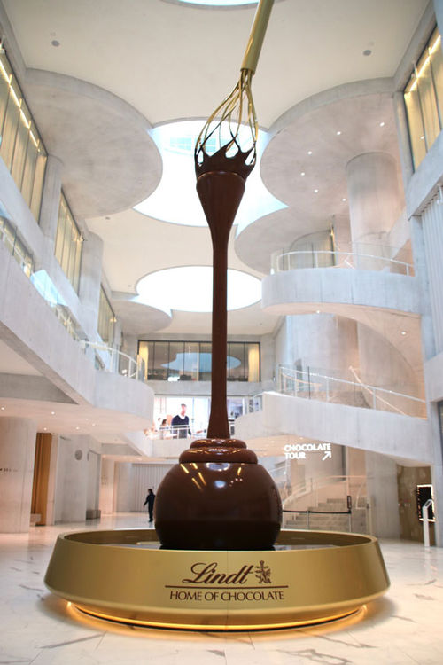 The 30.5-foot fountain spouting chocolate in the atrium at the Lindt Home of Chocolate in Kilchberg. The 30.5-foot fountain spouting chocolate in the atrium at the Lindt Home of Chocolate in Kilchberg.