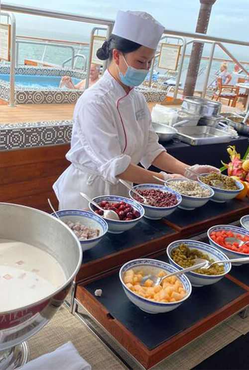 Many food options on the Yi Dun showcase Chinese cuisine, like this station with sweet coconut milk and several accompaniments, like melon, beans and sago pearls.