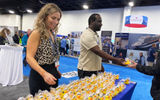 This year's CruiseWorld had the largest turnout on record, with 1,400 people attending. That translated to a bustling trade show with 175 exhibiting companies. Advisors headed to booths representing cruise lines, hotels, resorts, destinations, touring companies, services and specialty organizations. Pictured from left, Kimberly Bertsch and Tavares Sheely, customer relations specialists for Port Everglades, stand ready to pass out cruise duckies to travel advisors. Their aim was also to tell sell advisors on how convenient the port is to cruise out of due to its proximity to the Fort Lauderdale Airport and the variety of lines cruising out of Port Everglades.