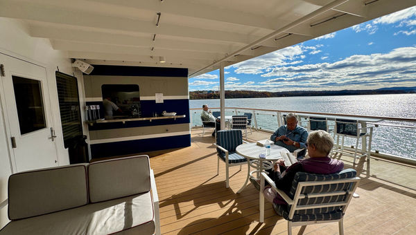 Guests enjoy some unseasonably warm November weather on the outdoor patio of Deck 3 as they wait for their meals from the Lookout Cafe.