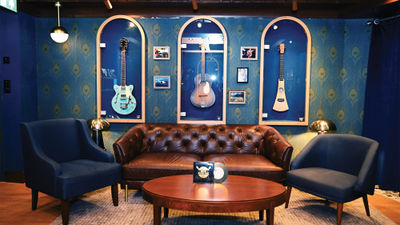 Guitars hang on the walls in glass cases in the Quietly Making Noise speakeasy aboard the Margaritaville at Sea Islander, including one that belonged to Jimmy Buffett.