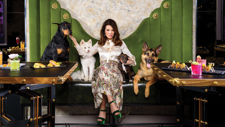 Lisa Vanderpump poses with a few canine friends at the Vanderpump Cocktail Garden at the Caesars Palace Las Vegas.
