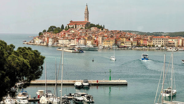 The bell tower of the Church of St. Euphemia looms over Croatian seaside city of Rovinj. The bell tower of the Church of St. Euphemia looms over Croatian seaside city of Rovinj.