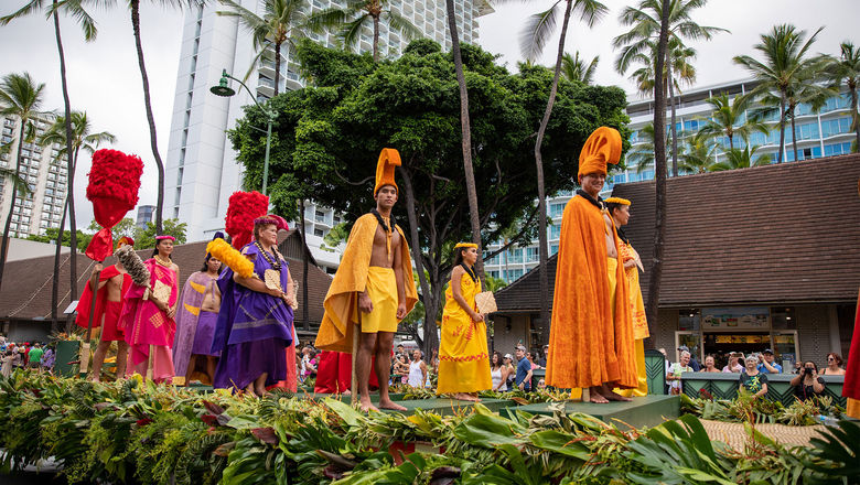 During the annual Aloha Festivals Floral Parade, a royal court wearing Hawaiian regalia passes down Kalakaua Avenue.
