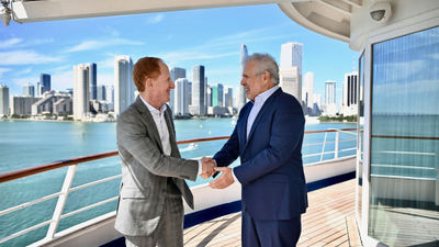 Russell Galbut, managing principal at Crescent Heights, left, shakes hands with Harry Sommer, president and CEO of  Norwegian Cruise Line Holdings.