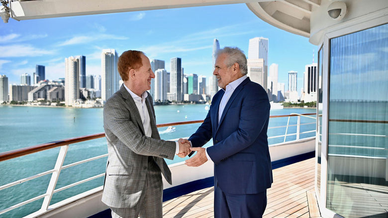 Russell Galbut, managing principal at Crescent Heights, left, shakes hands with Harry Sommer, president and CEO of  Norwegian Cruise Line Holdings.