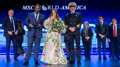 From left, cruise director Everson Bevelle, ship godmother Drew Barrymore and Capt. Dino Sagani at the christening of the MSC World America in Miami on April 9.