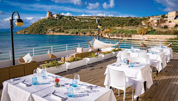 The Calamosca restaurant offers a refined take on traditional Sardinian and Mediterranean cuisine, emphasizing fresh, local seafood and seasonal ingredients in its dishes. The Calamosca restaurant offers a refined take on traditional Sardinian and Mediterranean cuisine, emphasizing fresh, local seafood and seasonal ingredients in its dishes.