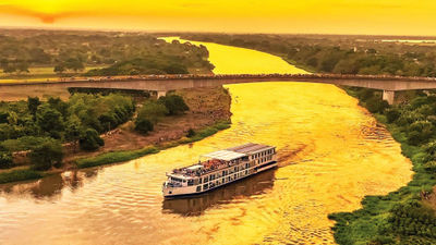 Locals gather on a bridge and on the riverbank to see the new AmaMagdalena.
