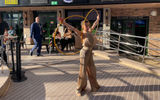 An acrobat performs outside of the All-Stars Sports Bar along the World Promenade on April 9, the evening of the christening ceremony.