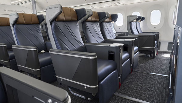 American's new premium economy seats have larger entertainment screens as well as arms extending from the headrests for additional privacy. American's new premium economy seats have larger entertainment screens as well as arms extending from the headrests for additional privacy.