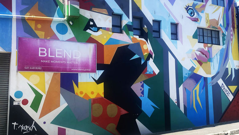 This colorful mural by French artist Tim Marsh shows a woman and a lion, symbolizing the interdependence between people and wildlife.